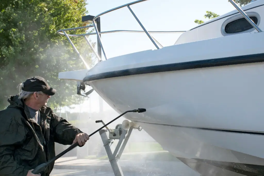 image of boat owner cleaning the hull of a boat to increase fuel efficiency