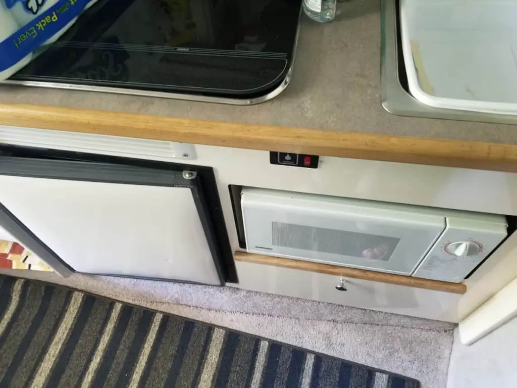 image showing the author's marine refrigerator in the galley of his cuddy cabin boat.