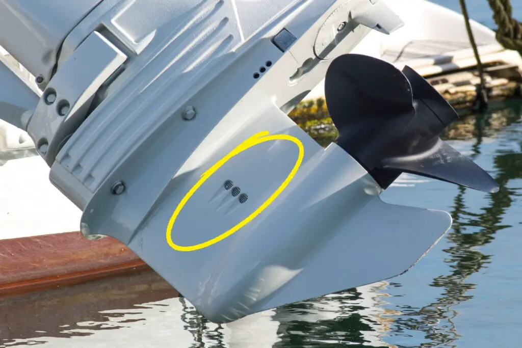 image showing where to place muffs over the water intake on an outboard engine
