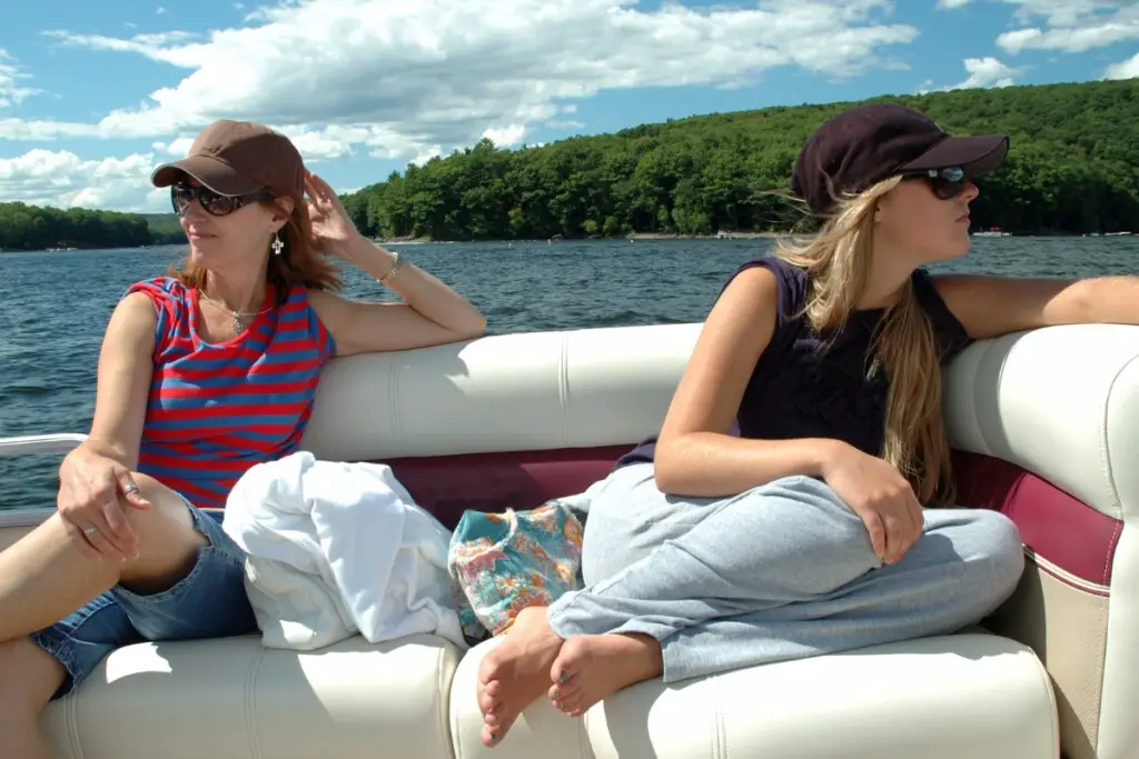two women on a boat wearing shades
